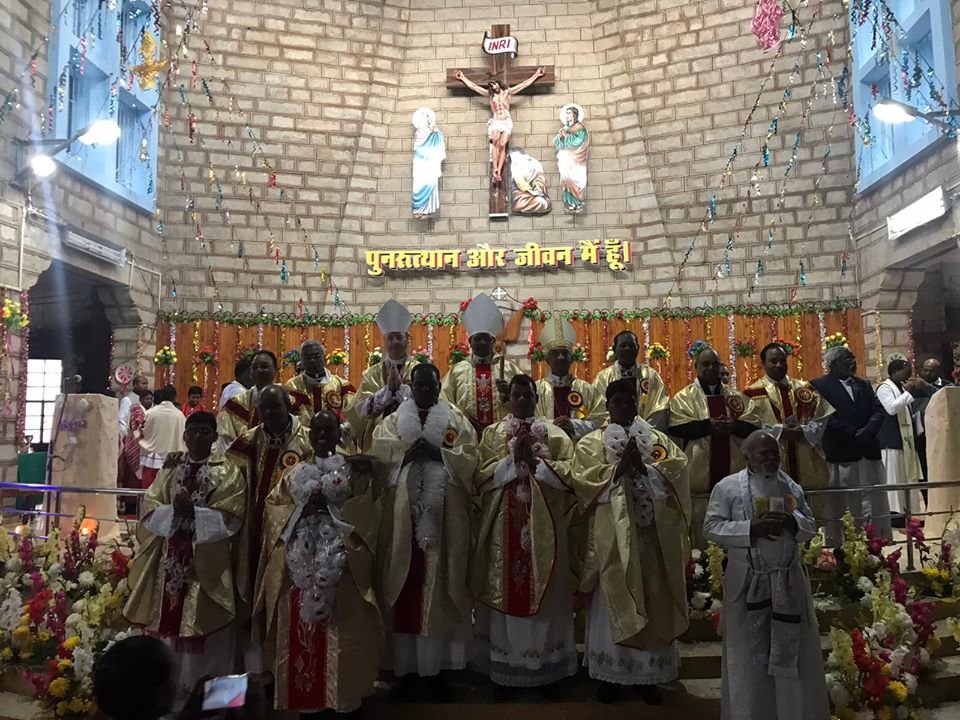 Bishop McKnight joins fellow bishops and newly ordained priests in the sanctuary of the Cathedral of the Holy Rosary in Kunkuri Jan. 4, after presiding at an Ordination Mass.